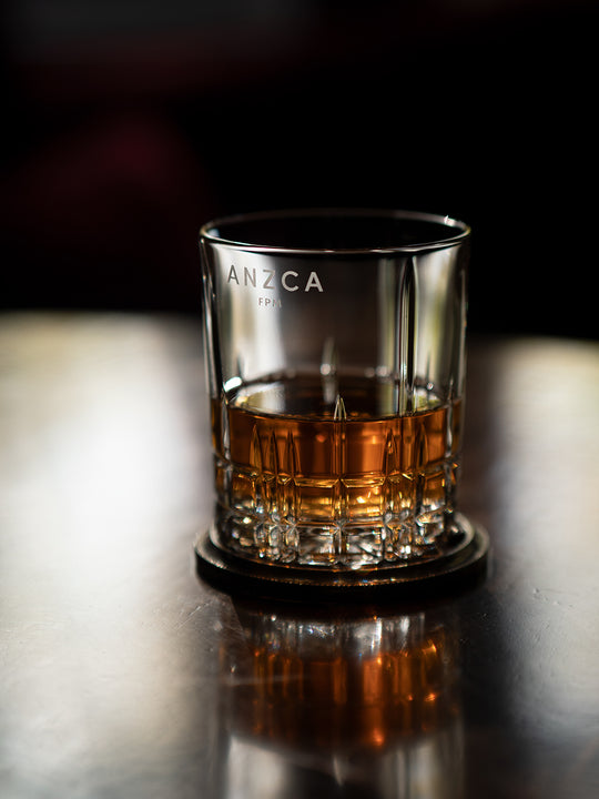 double old fashioned personalised glass with corporate logo sitting on a table on coaster. Designed for corporate gifting