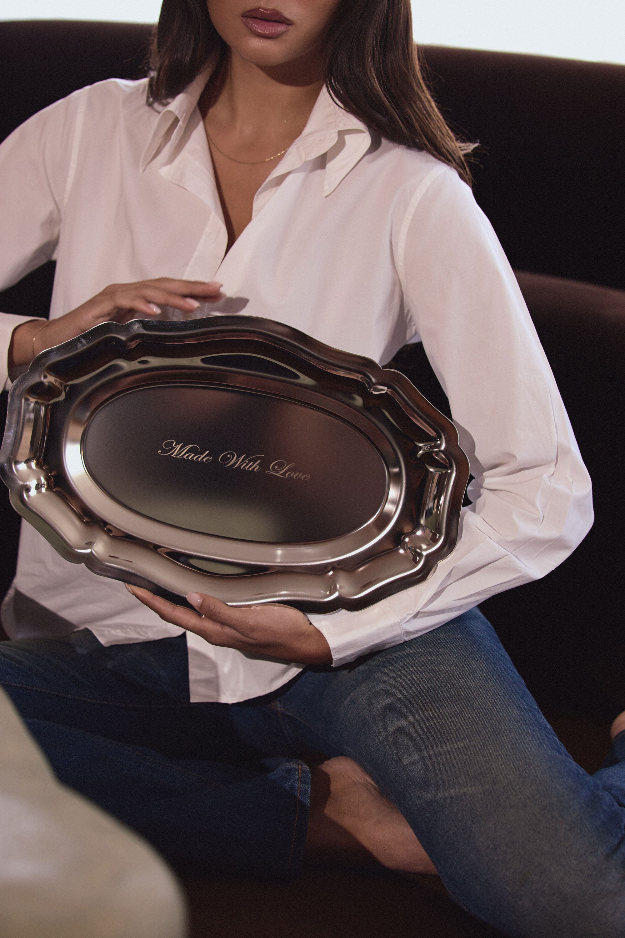Person holding a silver tray with 'Made With Love' engraving